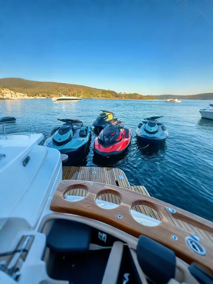 A jet ski speeding through the waters of Búzios, with the coastline visible in the background.