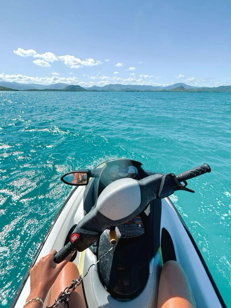 A panoramic view of Praia de Geribá, with several jet skis visible in the water.